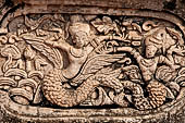 Chiang Mai - The Wat Phra Singh temple. The ho trai (temple library). The stucco figures in high relief decorationg the base. 